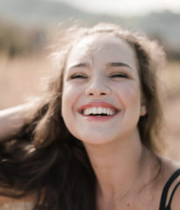 A woman smiling in sunlight